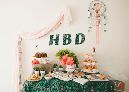 Plastic tablecloth streamers hung on a wall by a party table.