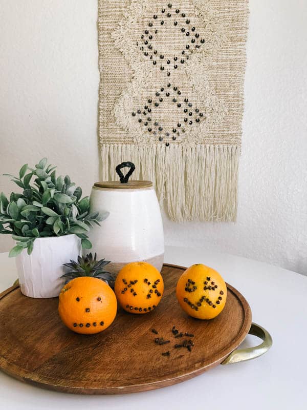 Pumpkin oranges with clove faces for a cheap Halloween decoration