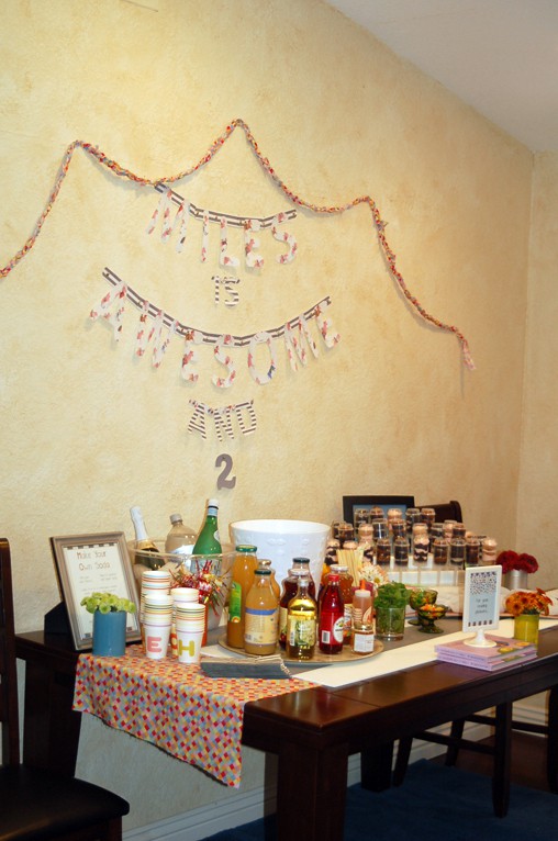 A food table at a kid's party based on a kid's book with a drink bar and wall decor. 