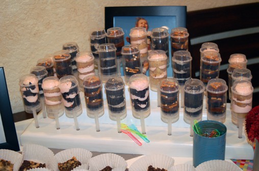 Push Pop cupcakes in a stand on a table. 