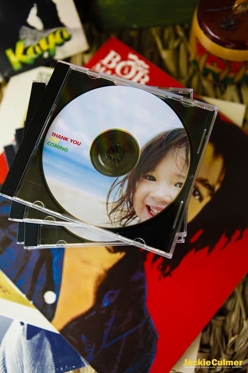 A stack of cds with a little girl's face on it. 