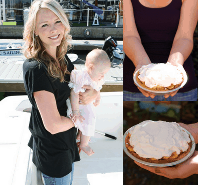 A woman holding a baby and a woman holding a pie. 