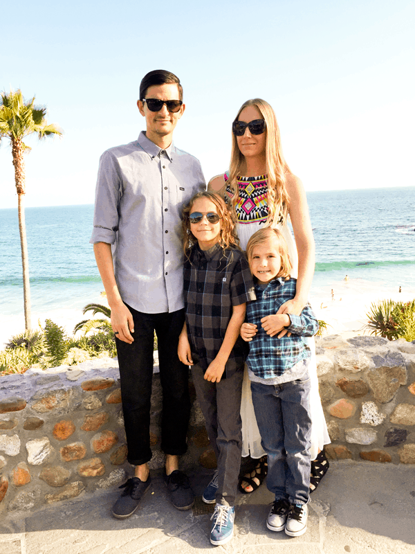 A family posed together in front of the ocean. 