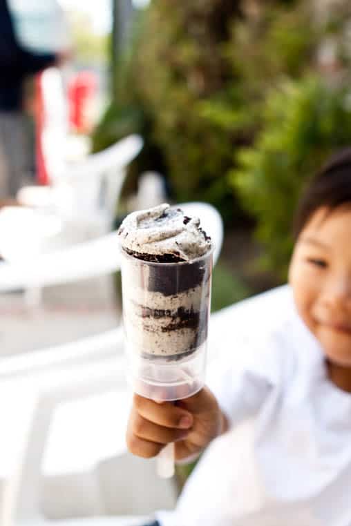 Kid holding a Push Up Cupcake. 