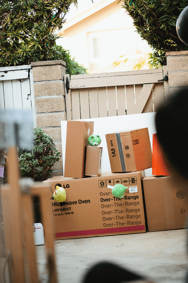 Boxes set up in the backyard to be knocked down with stuffed Angry Birds.