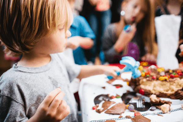 A child looking at a birthday cake. 