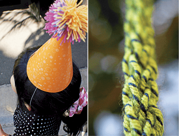 A party hat with a yarn pom on top and a braided yarn garland.