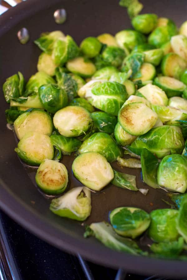 Sauteeing Brussels Sprouts with apple juice.