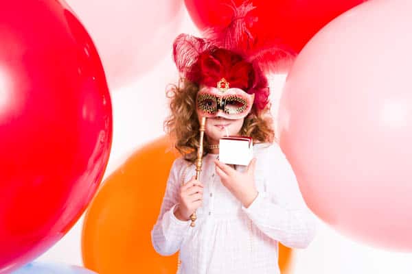 Little girl surrounded by big balloons.