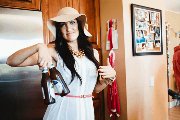 A woman holding beers.