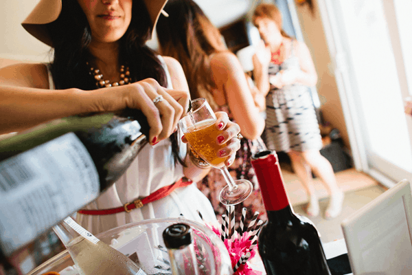 Woman pouring champagne into a glass.