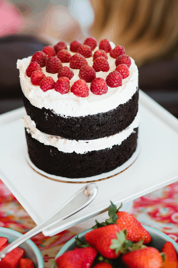 A layer cake with raspberries on top.