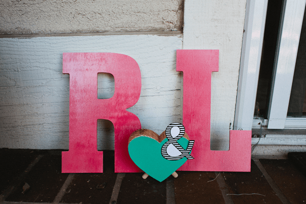 The letters \"r\" and \"L\" on a table next to a heart. 