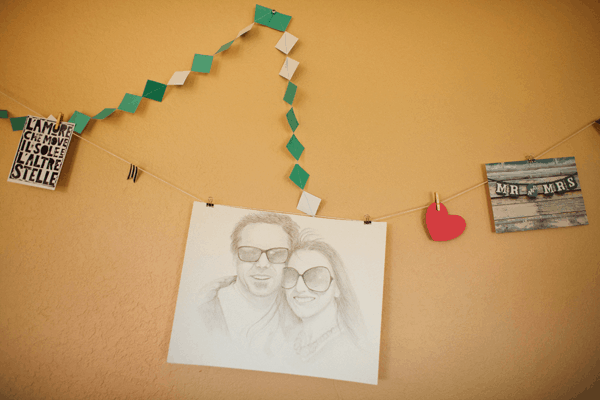 Bulletin board with a drawing of a couple and a garland.