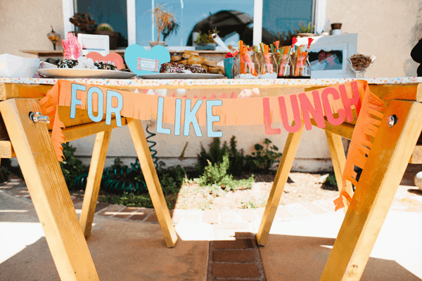 A food table for a bridal shower with a sign that says \"for, like, lunch.\"