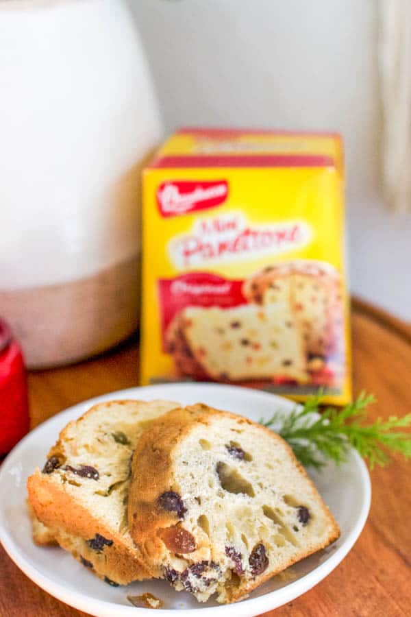 2 Panettone slices on a small white dessert plate. 