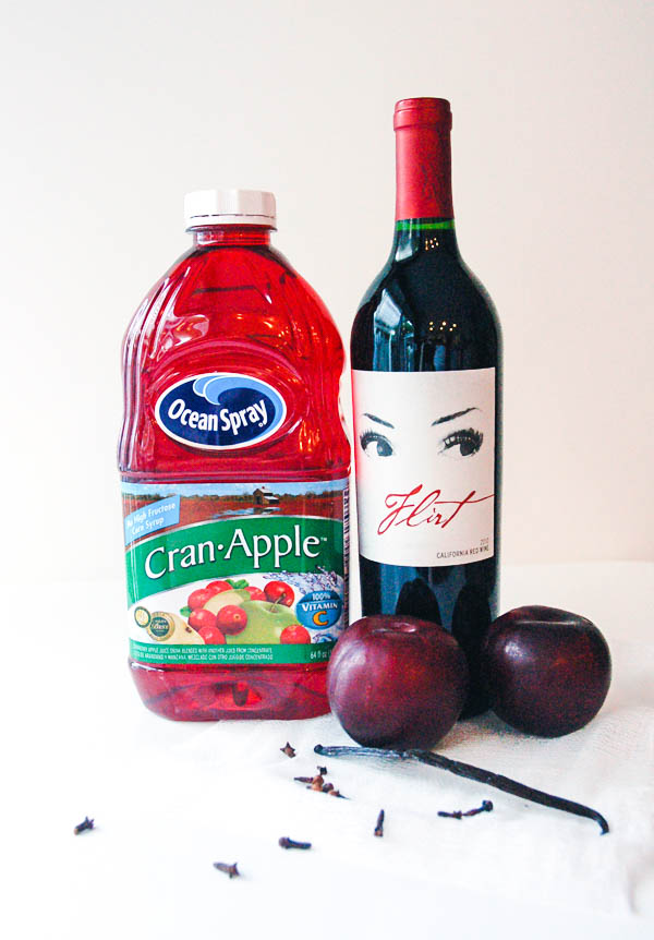 ingredients for a red wine sangria with plums, vanilla and cloves