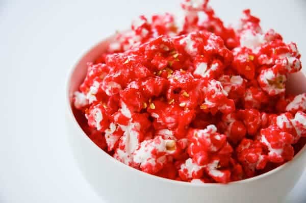pink candy coated pop corn in a bowl