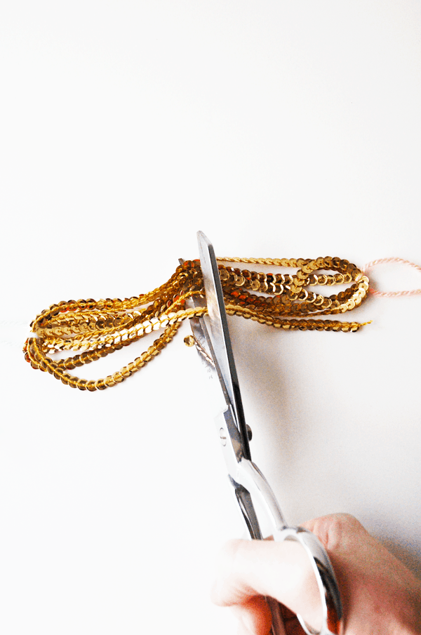 DIY gold sequin tassels are a great craft idea and party decoration! This tutorial is simple and you'll have gold sequin tassels all over your house in no time! 