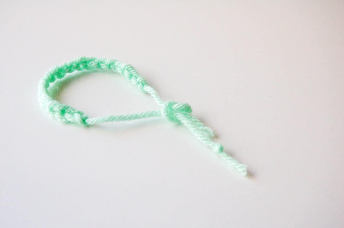 Close up of a finished knotted yarn bracelet.
