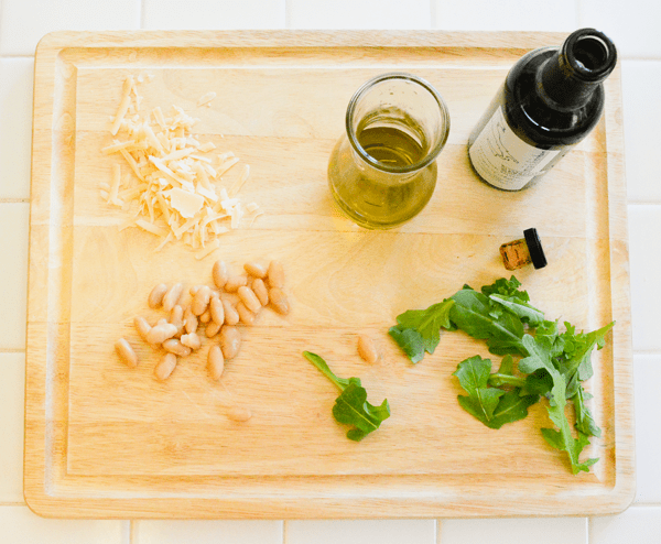 Ingredients laid out on a cutting board to make an Arugula White Bean Salad.