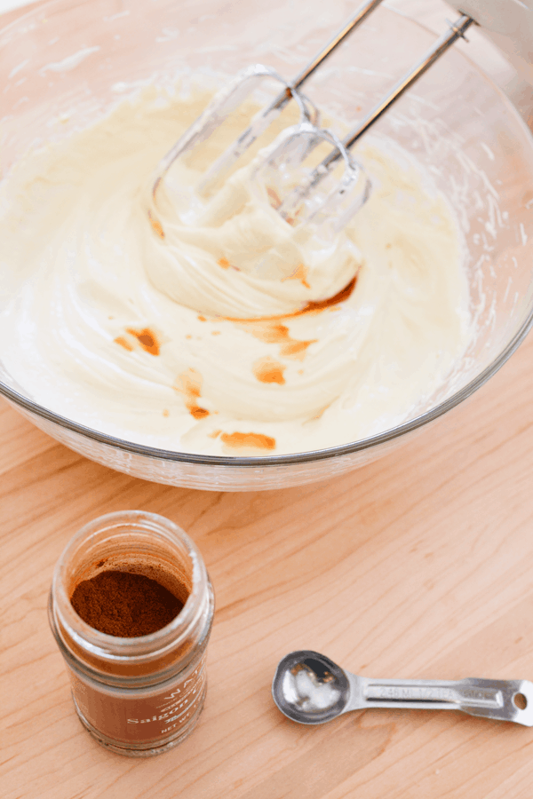 A bowl with whipped cream cheese and marshmallow cream with vanilla added before being mixed in. 