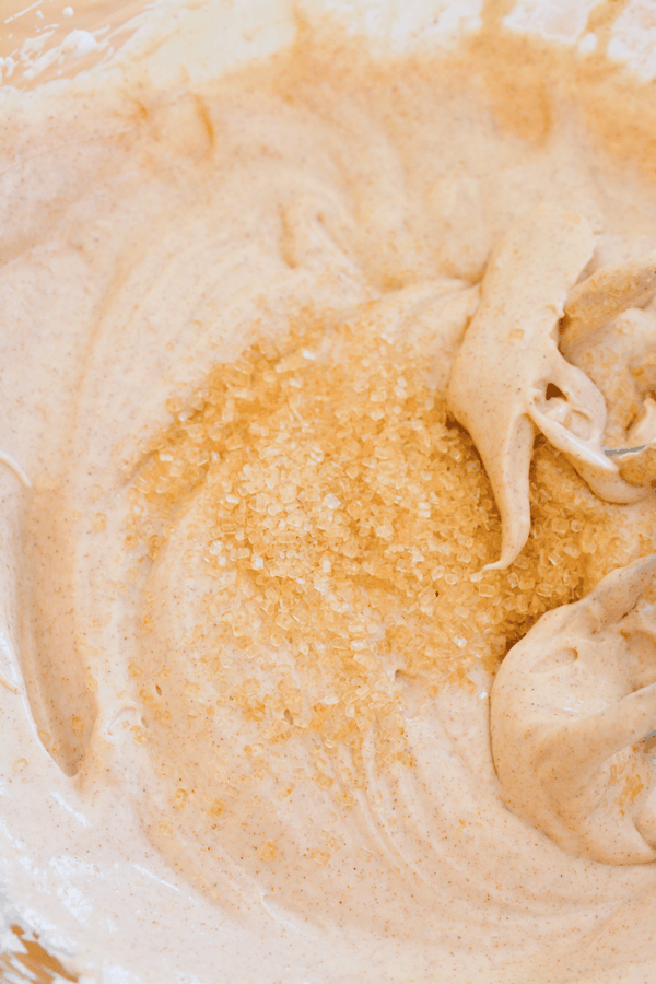 A bowl of fruit dip with turbinado sugar added before being mixed in. 