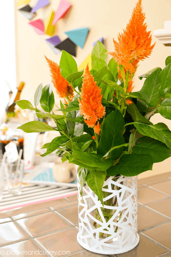 Orange flowers in a vase for a back to school brunch. 