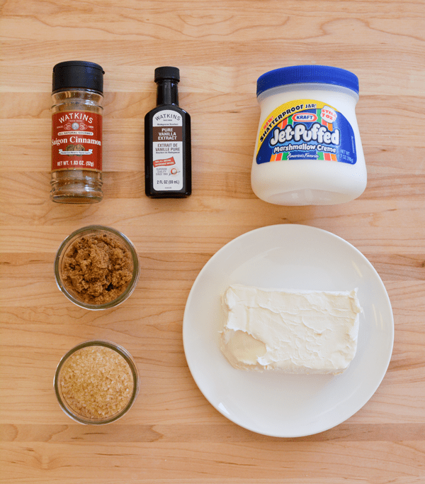 Ingredients needed to make a Churro fruit dip laid on a cutting board. 