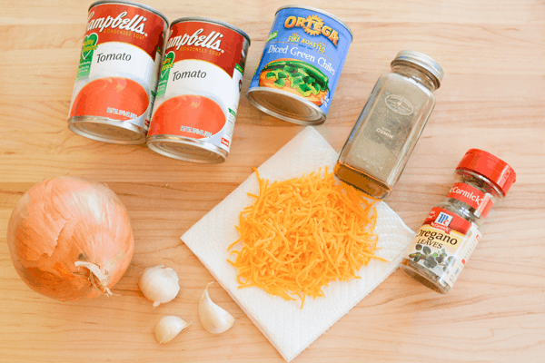 Ingredients to make pork chops topped with green chile and cheese. 