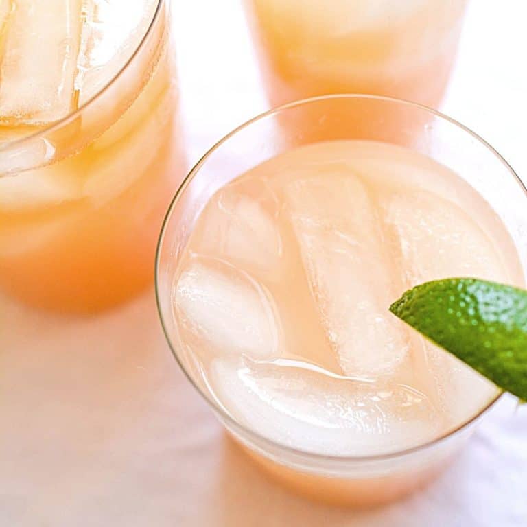 Close up of grapefruit cocktails on a table.