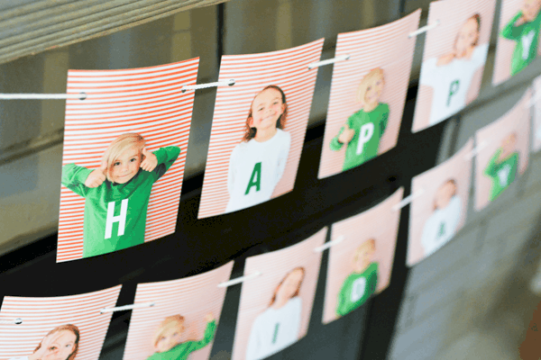 Close up of a personalized photo garland with kids and letters.