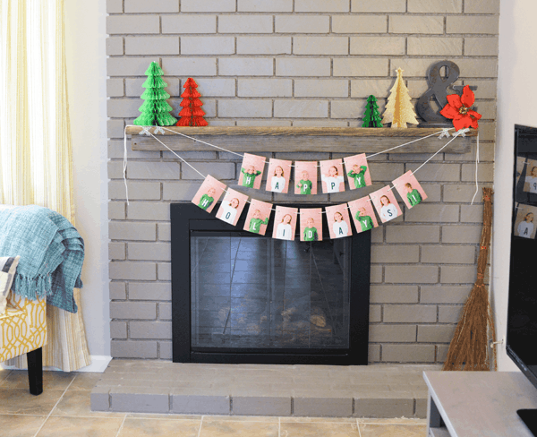 A holiday garland made from photos hanging from a mantle.