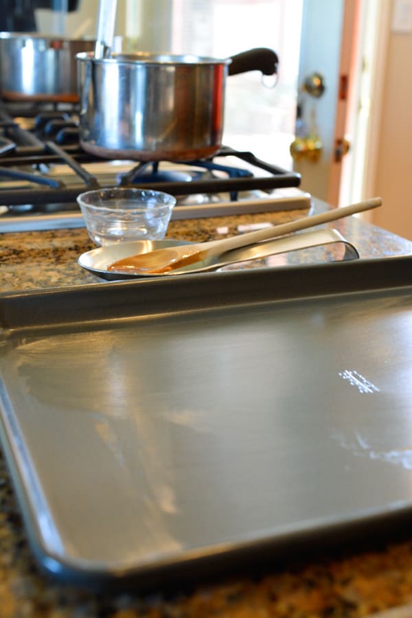 Sheet ban greased with oil on the countertop.