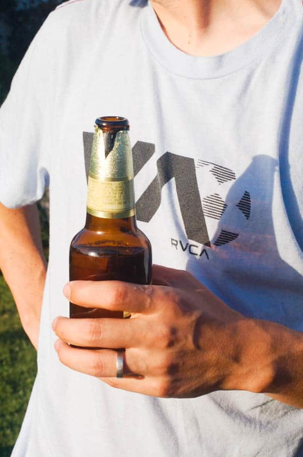man holding a bottle of Bohemia Beer