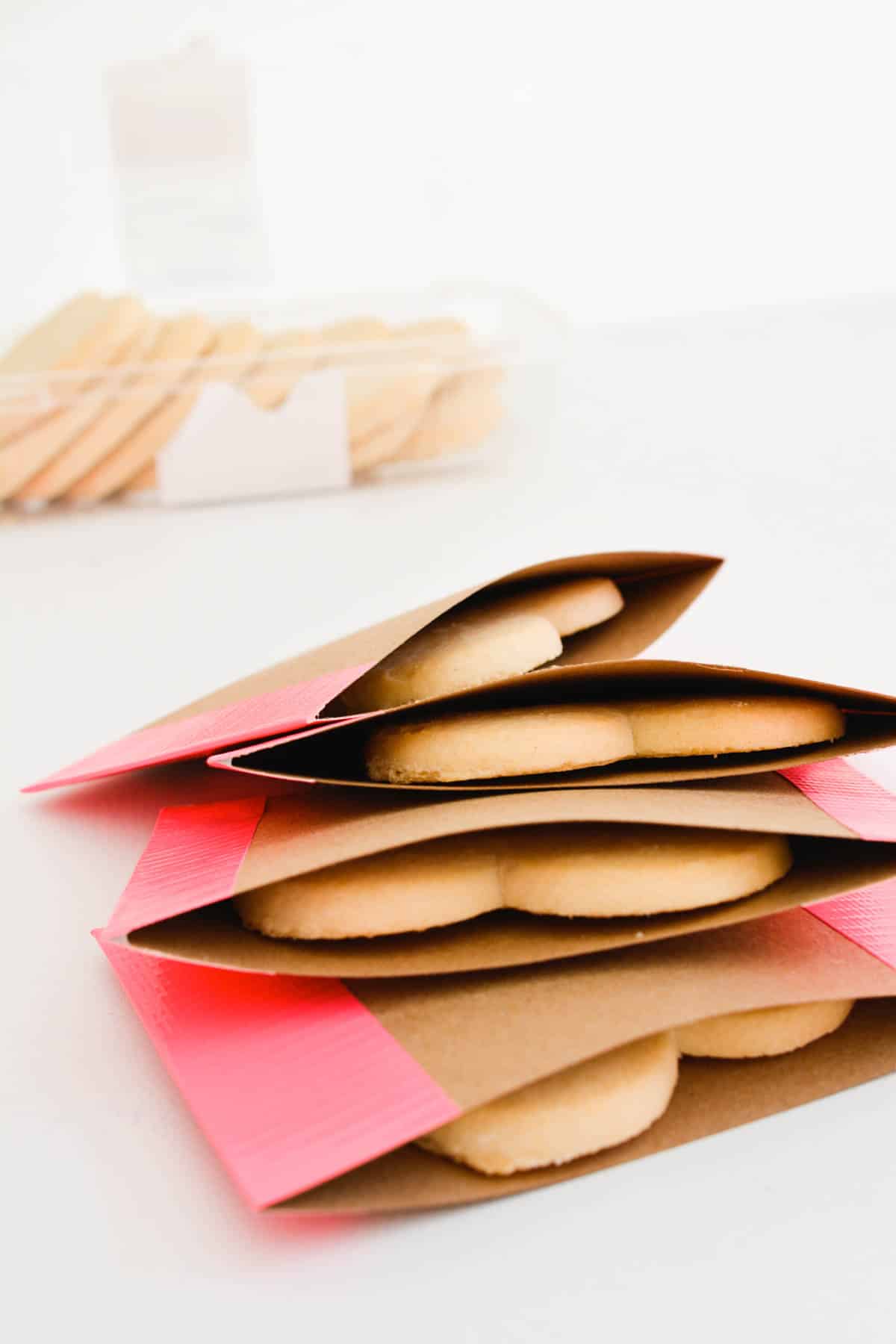 A stack of cookies packaged in little DIY envelopes made out of card stock.
