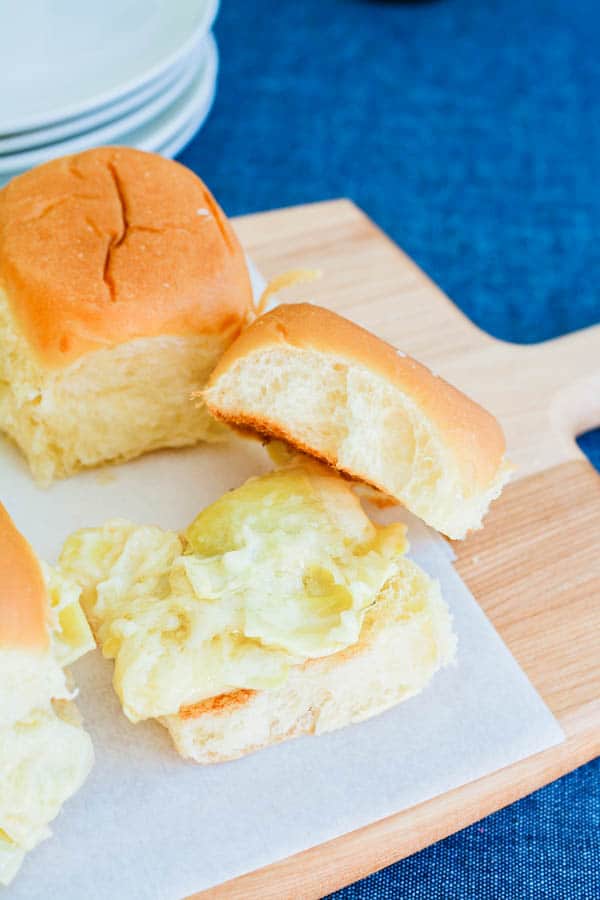 Artichoke Dip Sliders on a cutting board