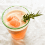 Blood orange gin float with rosemary stir stick.