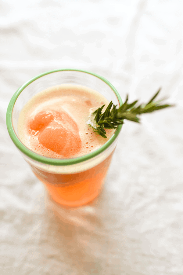 Blood orange gin float with rosemary stir stick.
