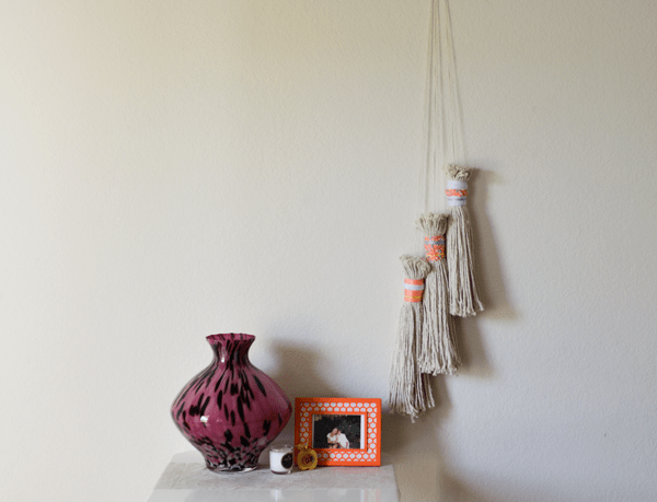 DIY tassel wall hanging out of mop heads. 