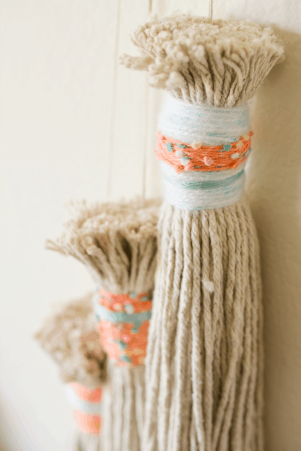 DIY wrapped tassels out of mop heads. 