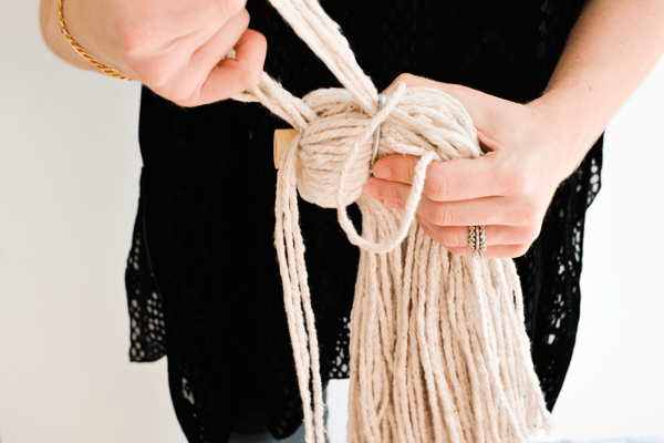Remove the metal band from the mop head to turn it in to a DIY tassel. 