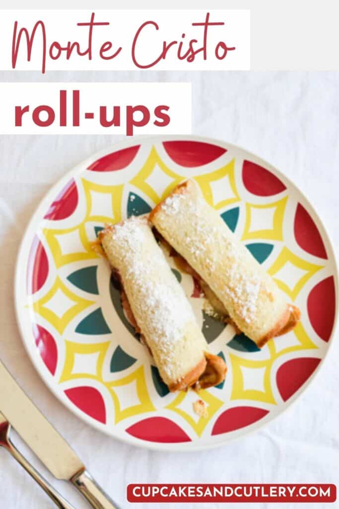 Text - Monte Cristo Roll-Ups with powdered sugar dusted rolled up bread sticks on a plate.