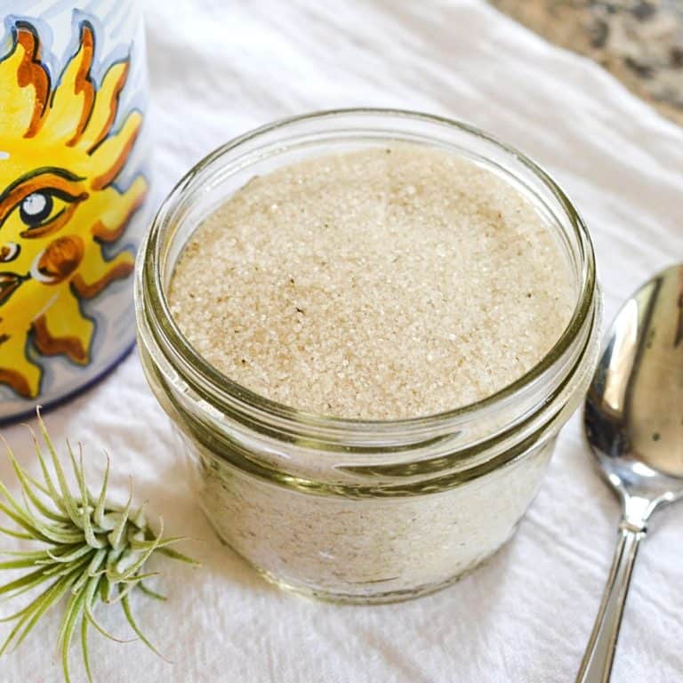 Close up of a glass jar of lavender sugar.