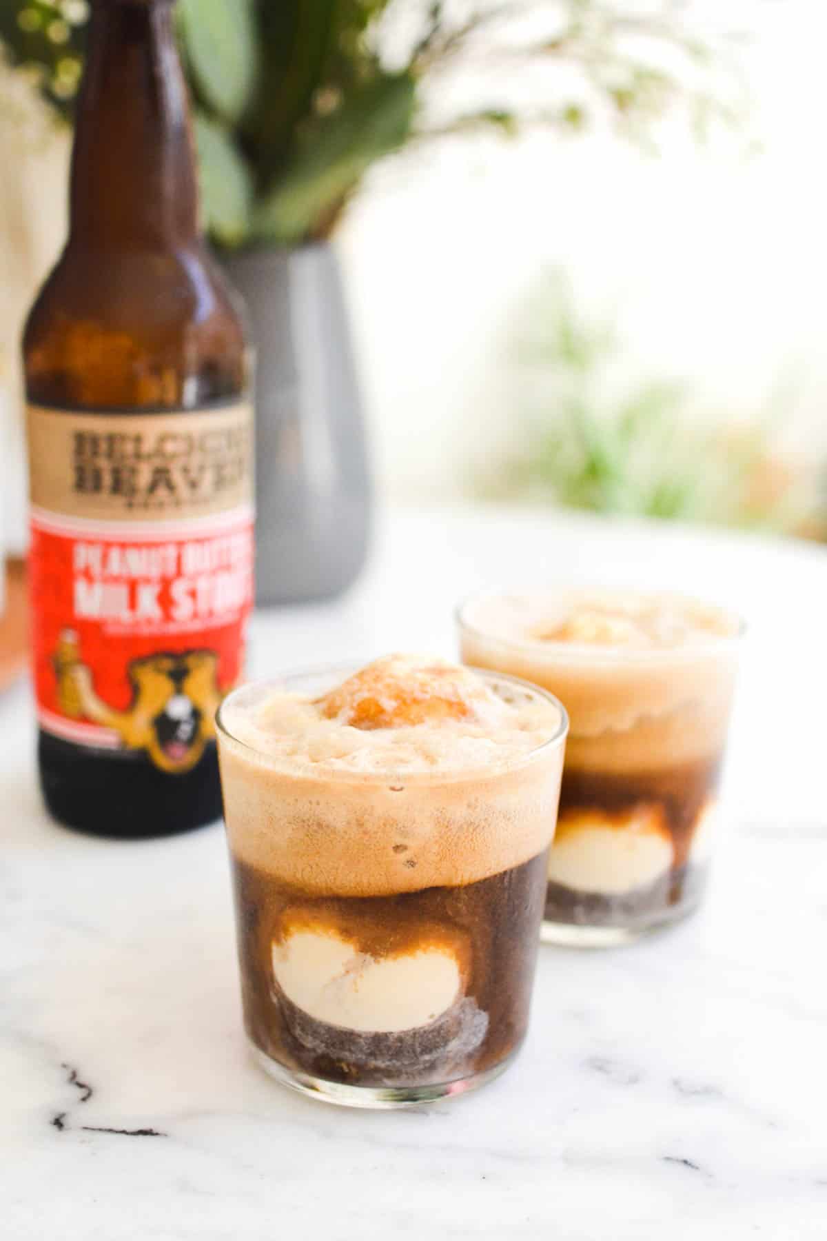 Close up fo short glasses holding ice cream and beer.