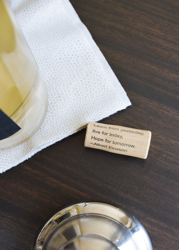 Close up of a quote written on a wine cork. 