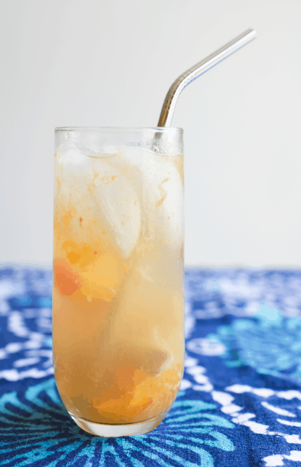 Delicious champagne cocktail with fresh ginger and peach. // www.cupcakesandcutlery.com