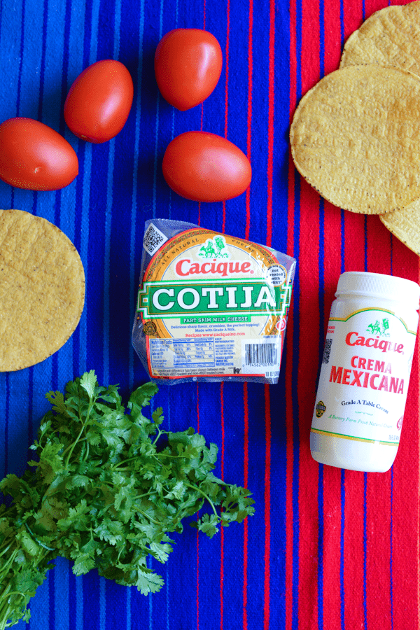Ingredients for a Mexican inspired caprese tostada recipe on a table. 