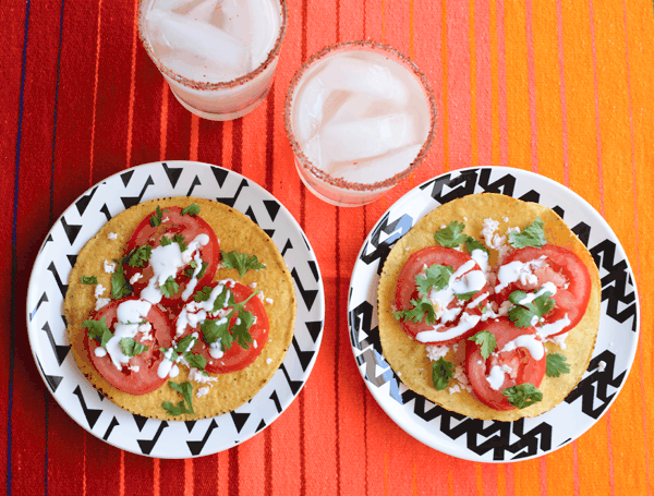 Overhead view of Caprese Tostada snacks on small plates.