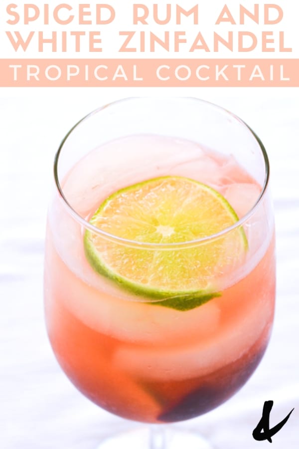 glass full of spiced rum and white zinfandel tropical cocktail
